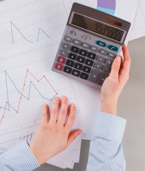 top-view-businesswoman-or-accountant-using-calcula-2022-02-09-19-29-53-utc-min